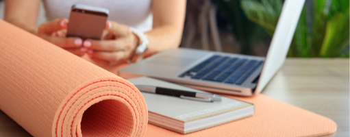 diary pen and laptop on a fitness mat